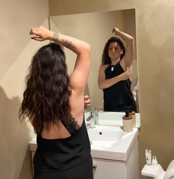 Jeune femme vérifiant la douceur de ses aisselles devant le miroir après une épilation laser — institut Secrets de Beauté Marie-Fleur, Rochefort-du-Gard